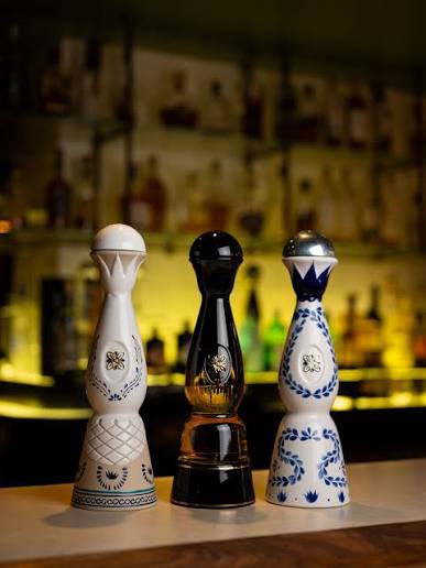 Three Clase Azul tequila decanters displayed on a bar counter